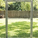 Aluminum greenhouse door frame with latch, clear view of a green backyard lawn and wooden fence.