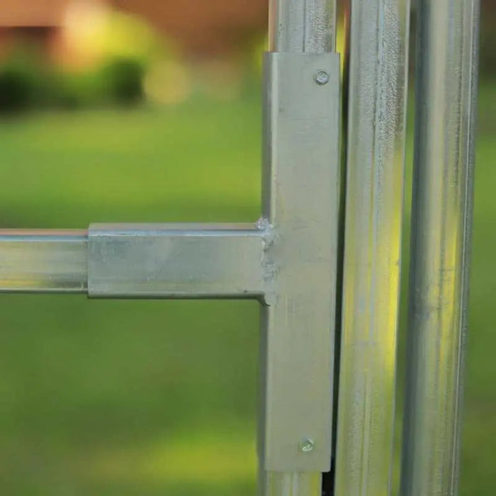 Galvanized steel T-bracket connecting square fence post and rail. Durable outdoor metal gate or panel hardware.