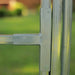 Galvanized steel T-bracket connecting square fence post and rail. Durable outdoor metal gate or panel hardware.