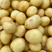 Fresh new golden potatoes, some with small brown spots. Healthy farm-fresh produce from The Farm on Central.
