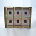 Galvanized metal 6-compartment sample holder with six black cubes. Lab equipment, industrial storage.