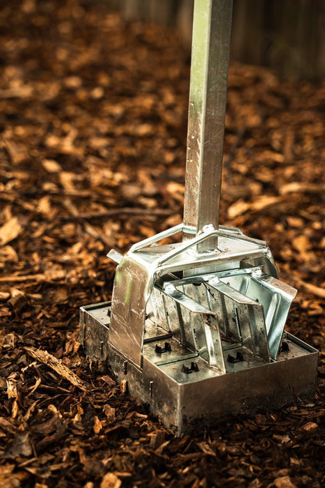 Metal soil block maker on wood chips. Gardening tool for efficient seed starting and plant propagation.